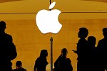 Apple warns on holiday sales, sending value below $1 trillion
