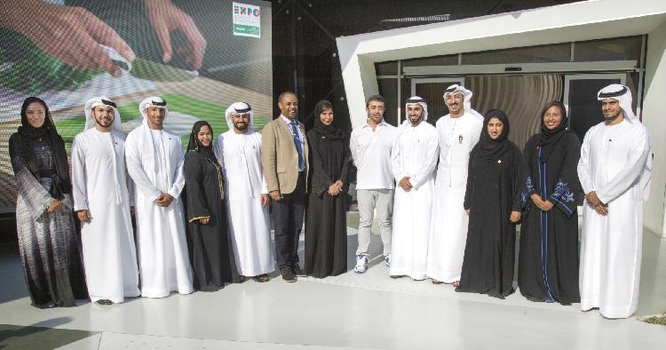 HH Sheikh Abdullah bin Zayed Al Nahyan, UAE Foreign Minister (sixth from right) is joined by Abdul Qader Hussein Ahmed, Etihad Airways Vice President Government and International Affairs (sixth from left), and a group of the airline's Emirati graduate managers, outside the Etihad Airways and Alitalia pavilion at Expo Milano 2015